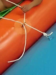 Positioning inflatable slide on water near dock site