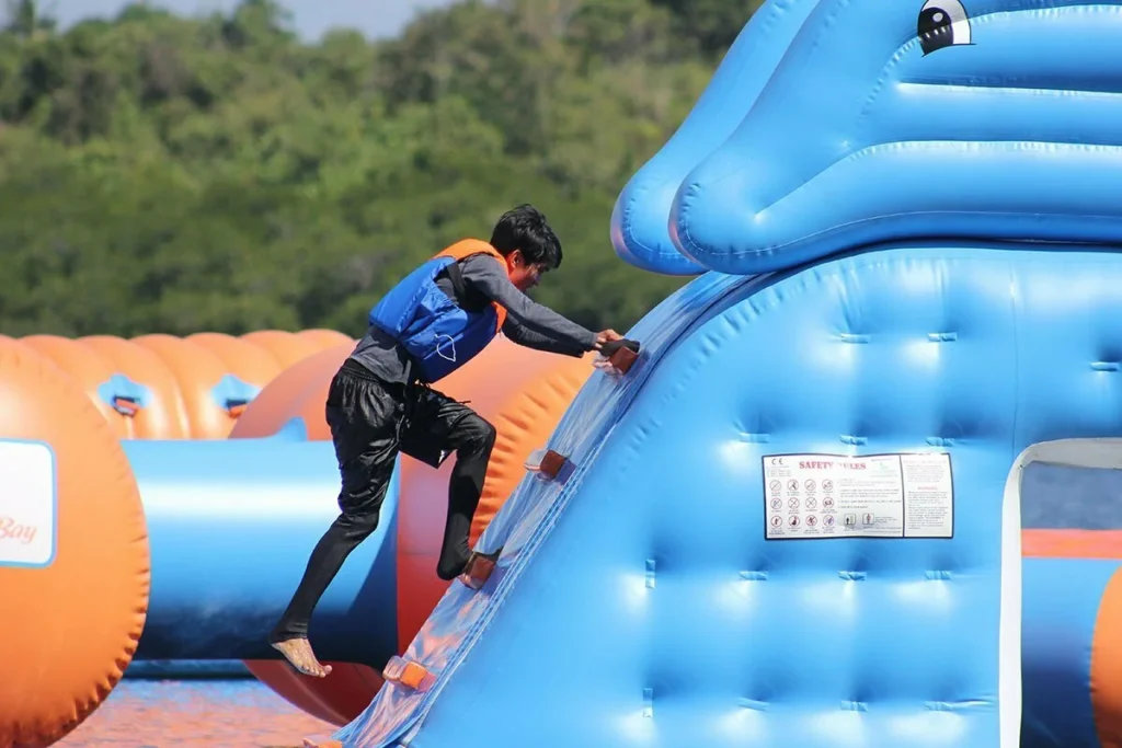 Inflatable water park with multi-level slide structure — commercial attraction