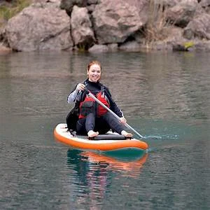 Person riding a towable inflatable water tube behind a speedboat