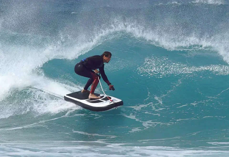 Water sports enthusiast stand up paddleboarding on calm ocean water