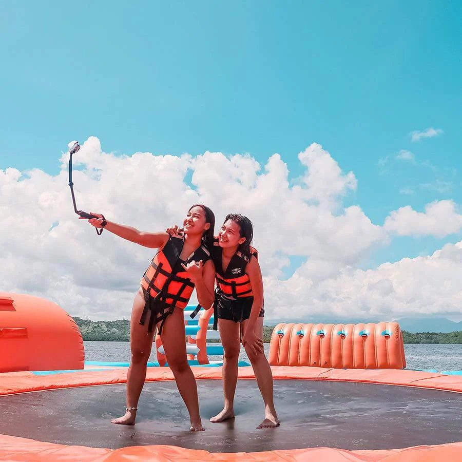 Inflatable water blob launcher and jumping cushion on water