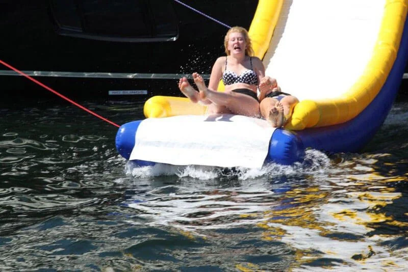 Custom inflatable water slide attached to a luxury motor yacht
