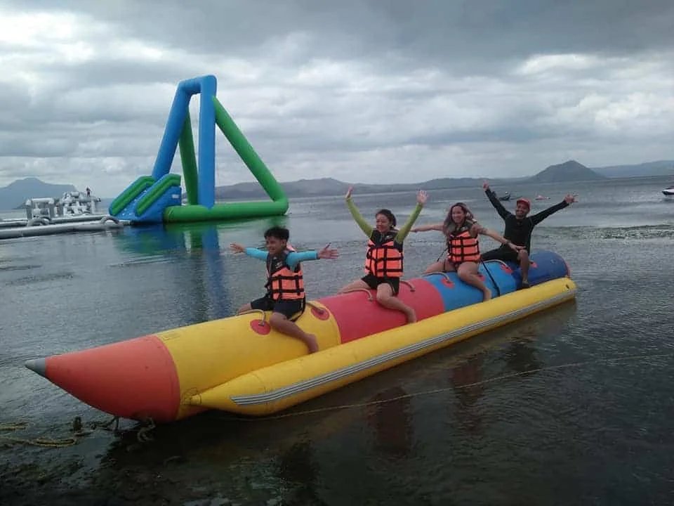 People jumping on floating water trampoline during summer vacation
