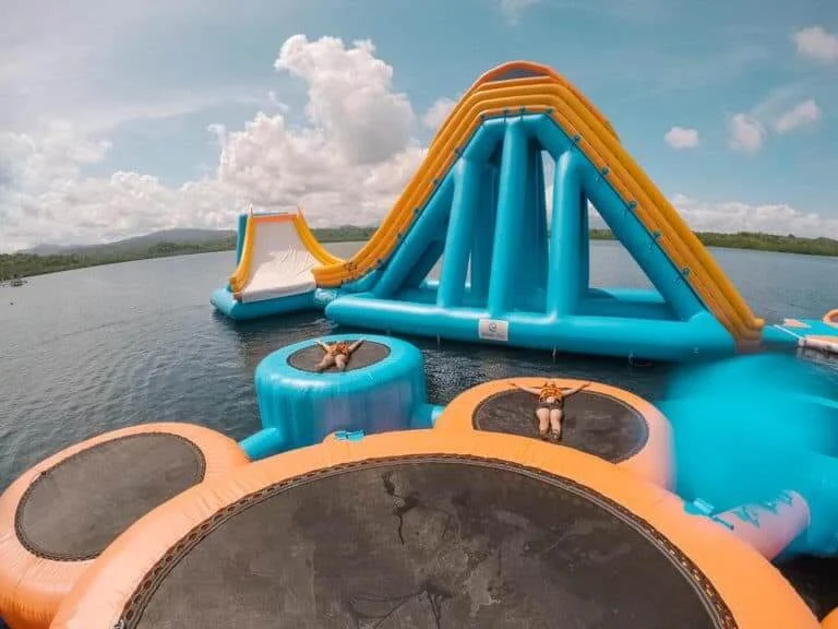 Tall inflatable slide structure designed for adult water park fun
