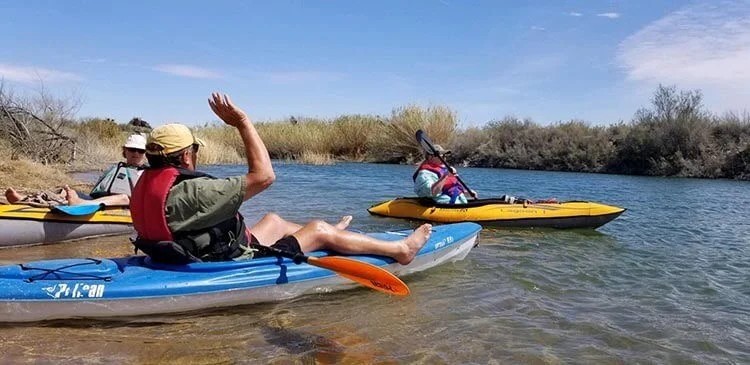 Rigid hardshell kayak mounted on car roof rack transport