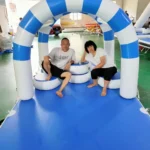 A man and woman sitting on a blue and white inflatable structure