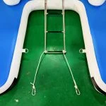 A ladder on a green surface